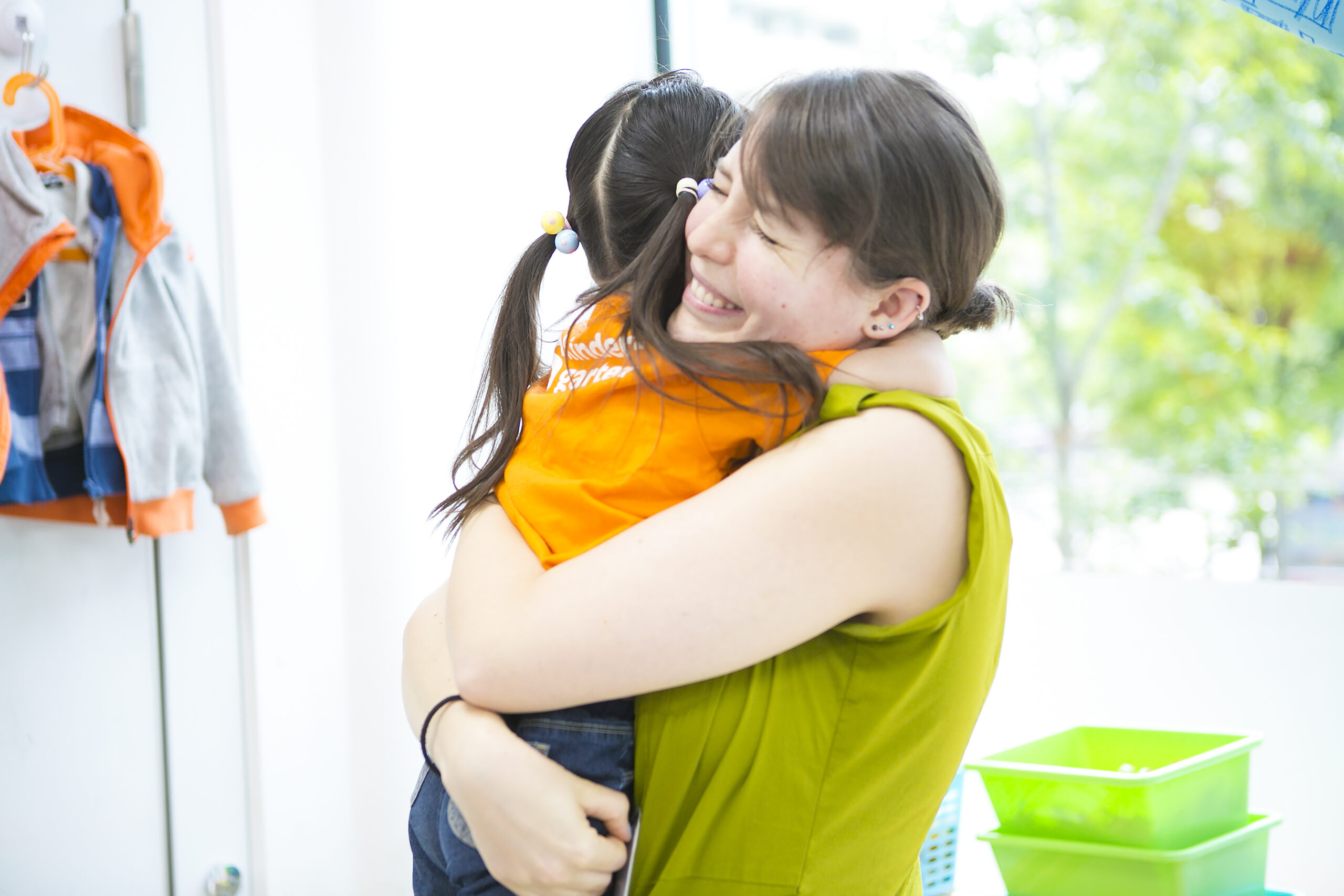 TISG teacher welcoming their students by giving them a hug